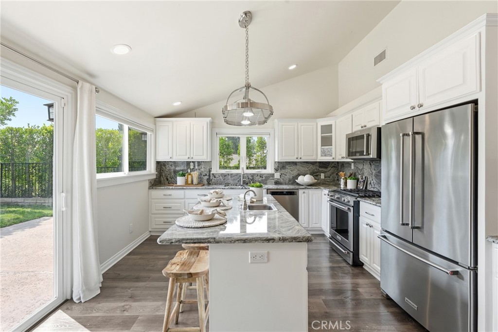 3240 Brace Canyon Road Burbank, CA 91504 - Photo 10 of 39 a kitchen with refrigerator a stove and wooden floor
