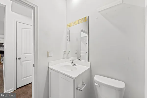 a bathroom with a toilet sink and mirror