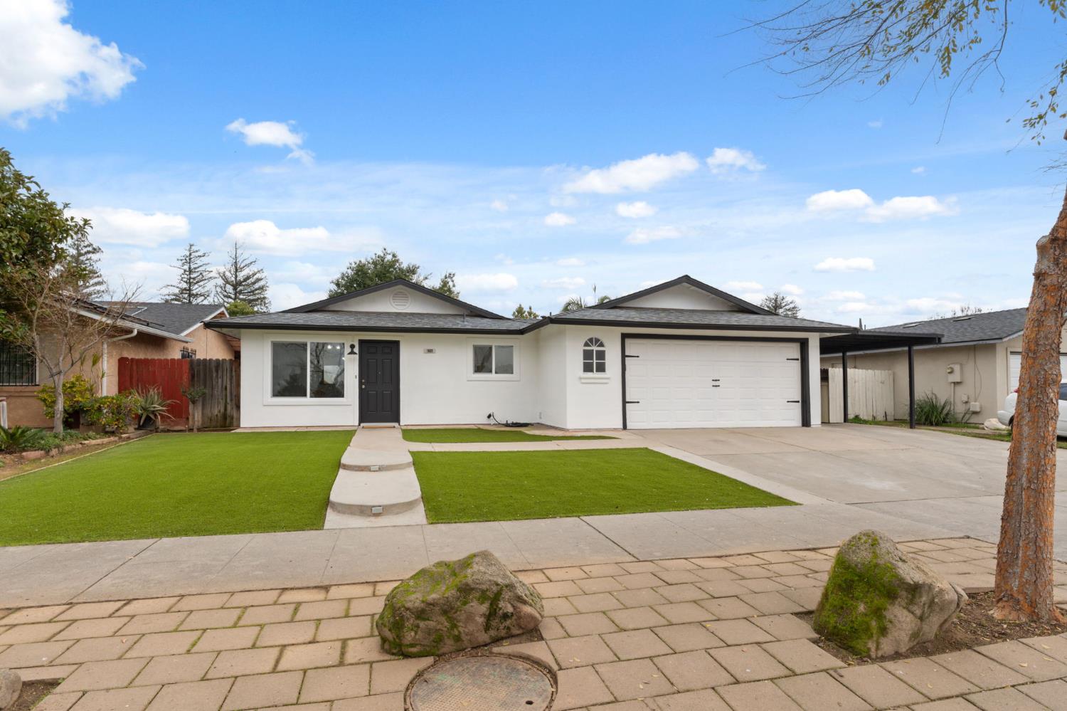 1601 Sonora Street Madera, CA 93638 - Photo 4 of 47 a front view of a house with a yard and garage