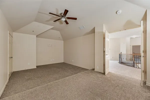 a view of a livingroom with a ceiling fan and entryway