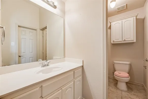 a bathroom with a sink a toilet and a mirror