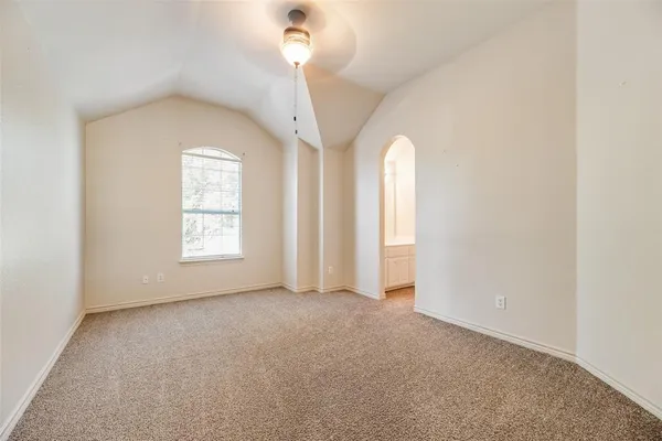 an empty room with windows and chandelier