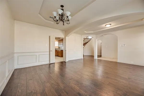 a view of an empty room and wooden floor