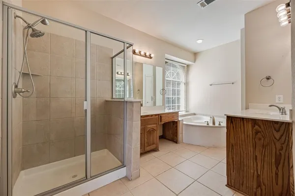 a bathroom with a granite countertop sink a toilet and shower