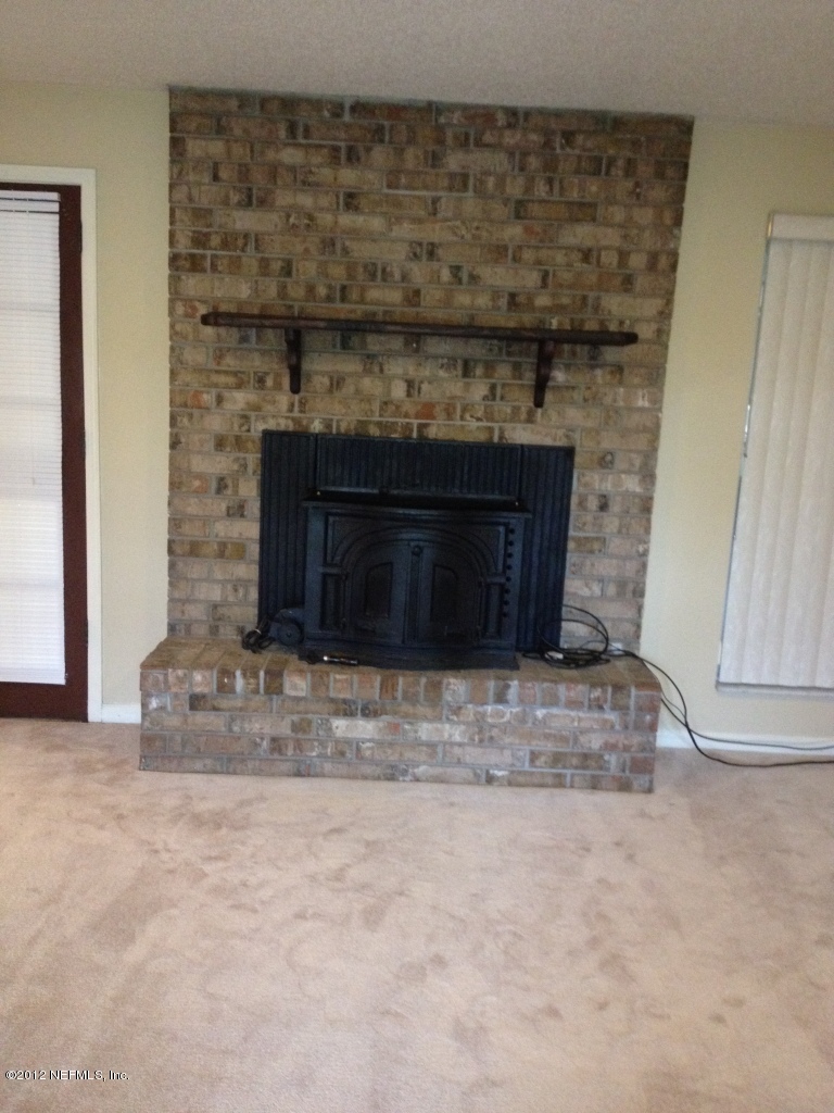 3969 Bramble Road Jacksonville, FL 32210 - Photo 10 of 12 Brick Fireplace with Wood Burning Insert