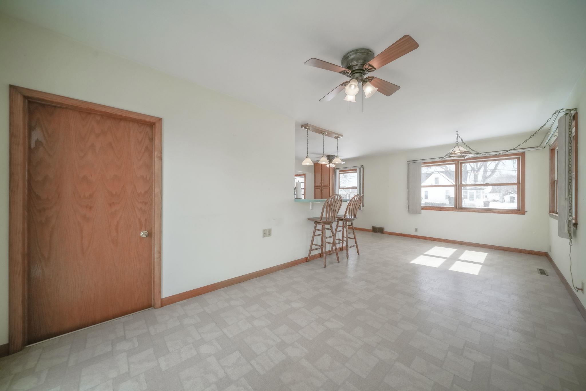 808 South 5th Street Oregon, IL 61061 - Photo 15 of 39 an empty room with windows and ceiling fan