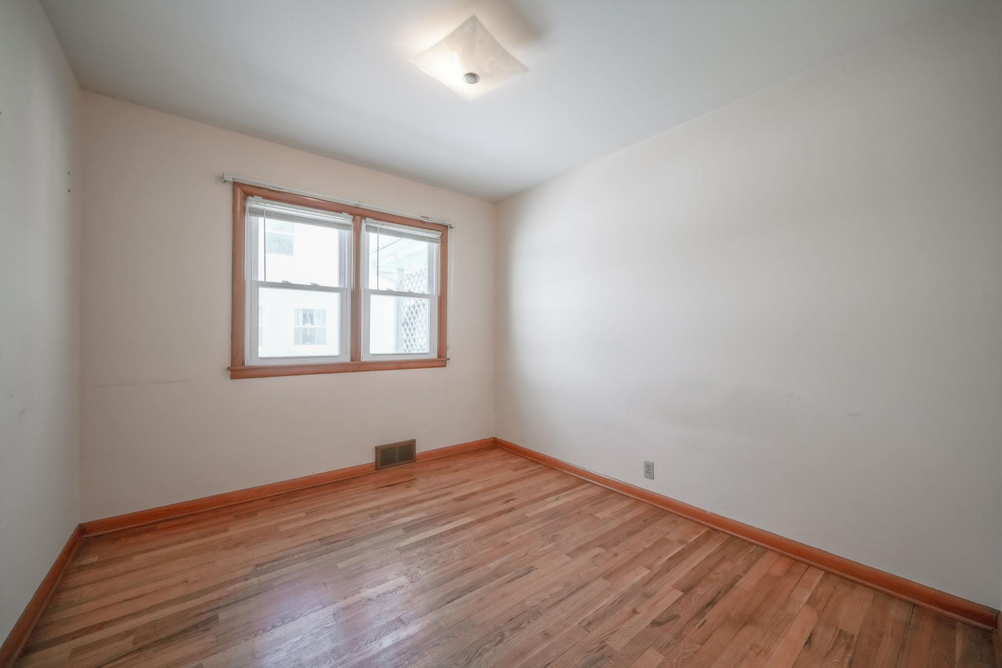 808 South 5th Street Oregon, IL 61061 - Photo 16 of 39 wooden floor in an empty room with a window