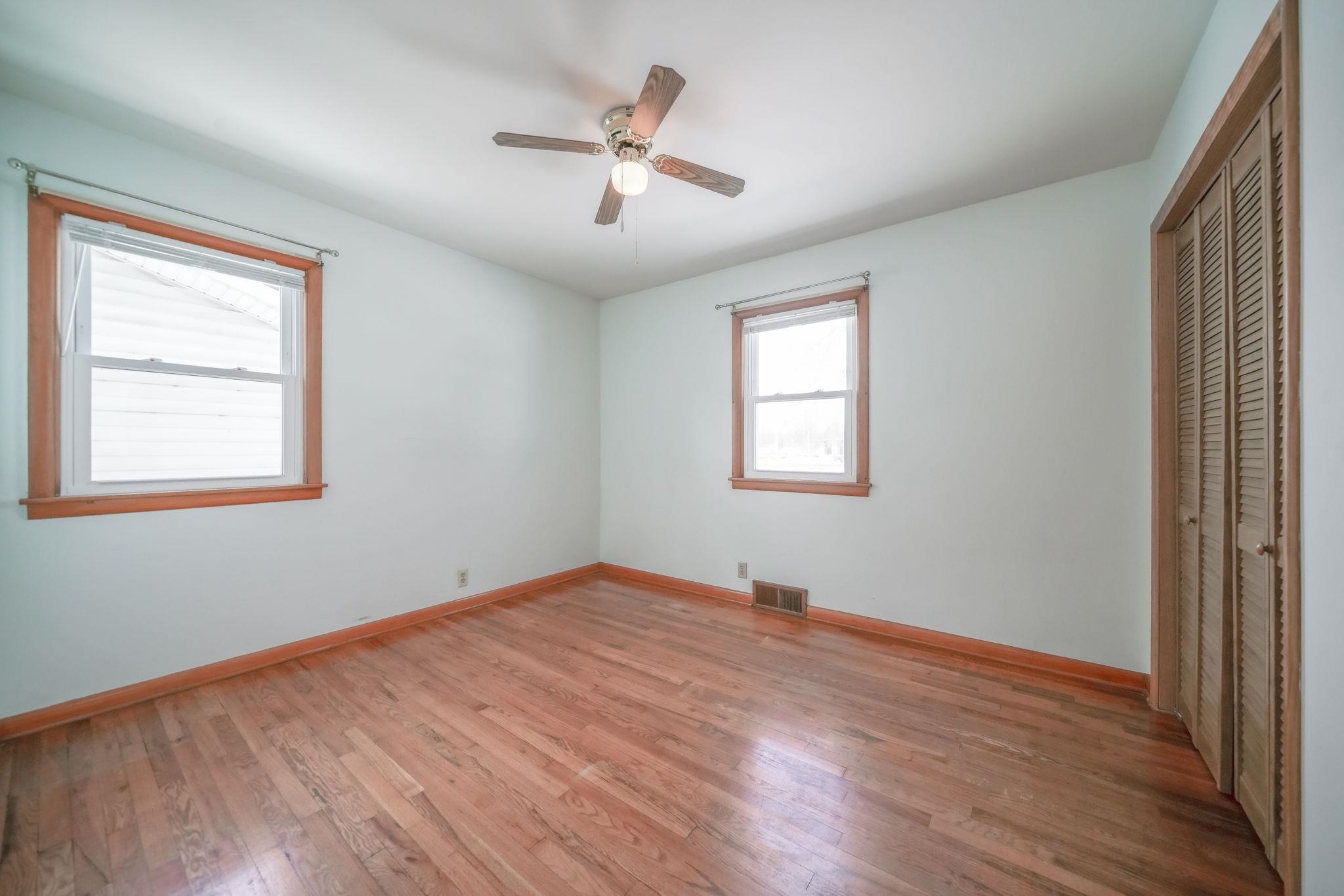 808 South 5th Street Oregon, IL 61061 - Photo 18 of 39 a view of an empty room with wooden floor and a window