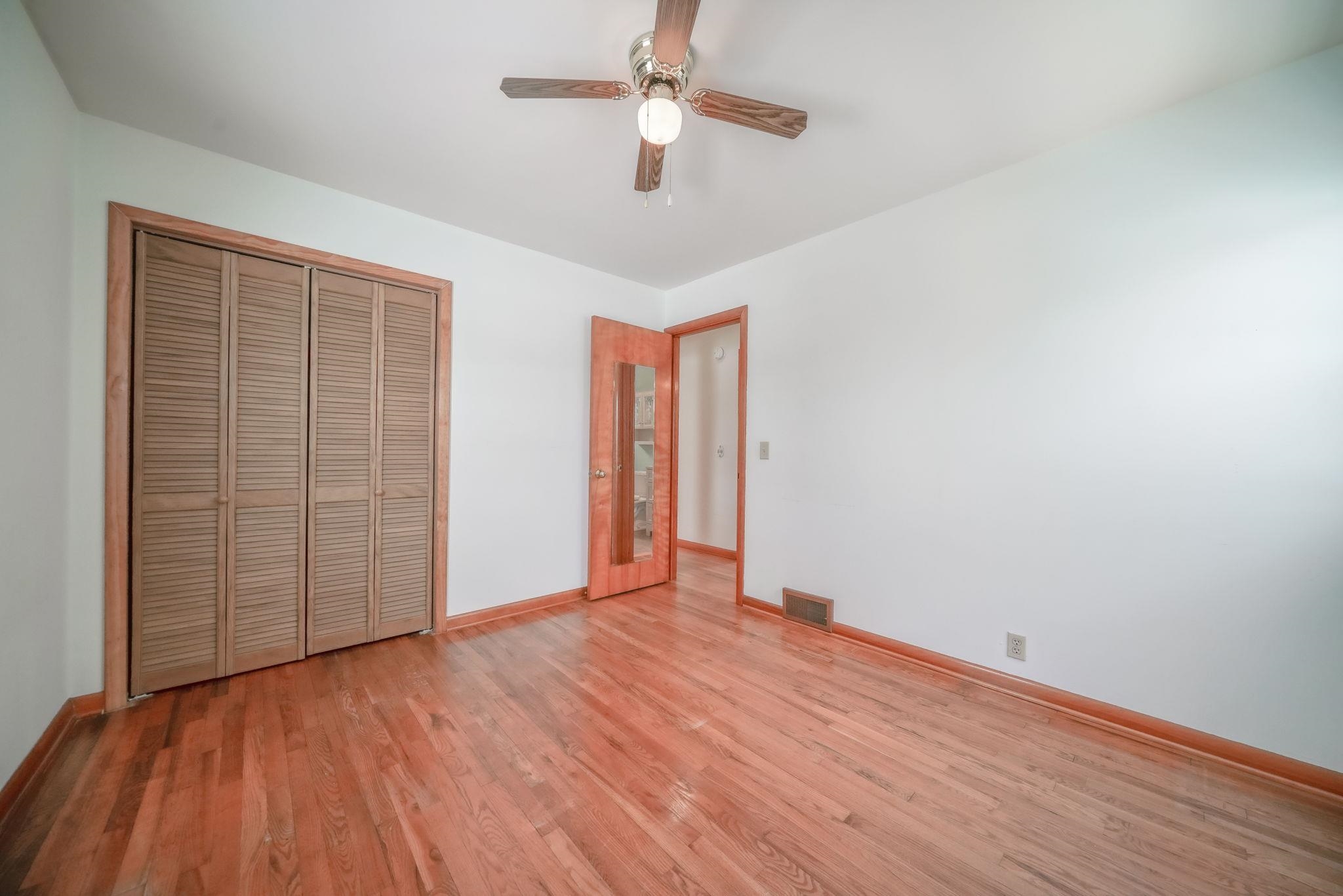 808 South 5th Street Oregon, IL 61061 - Photo 19 of 39 wooden floor in an empty room with a window