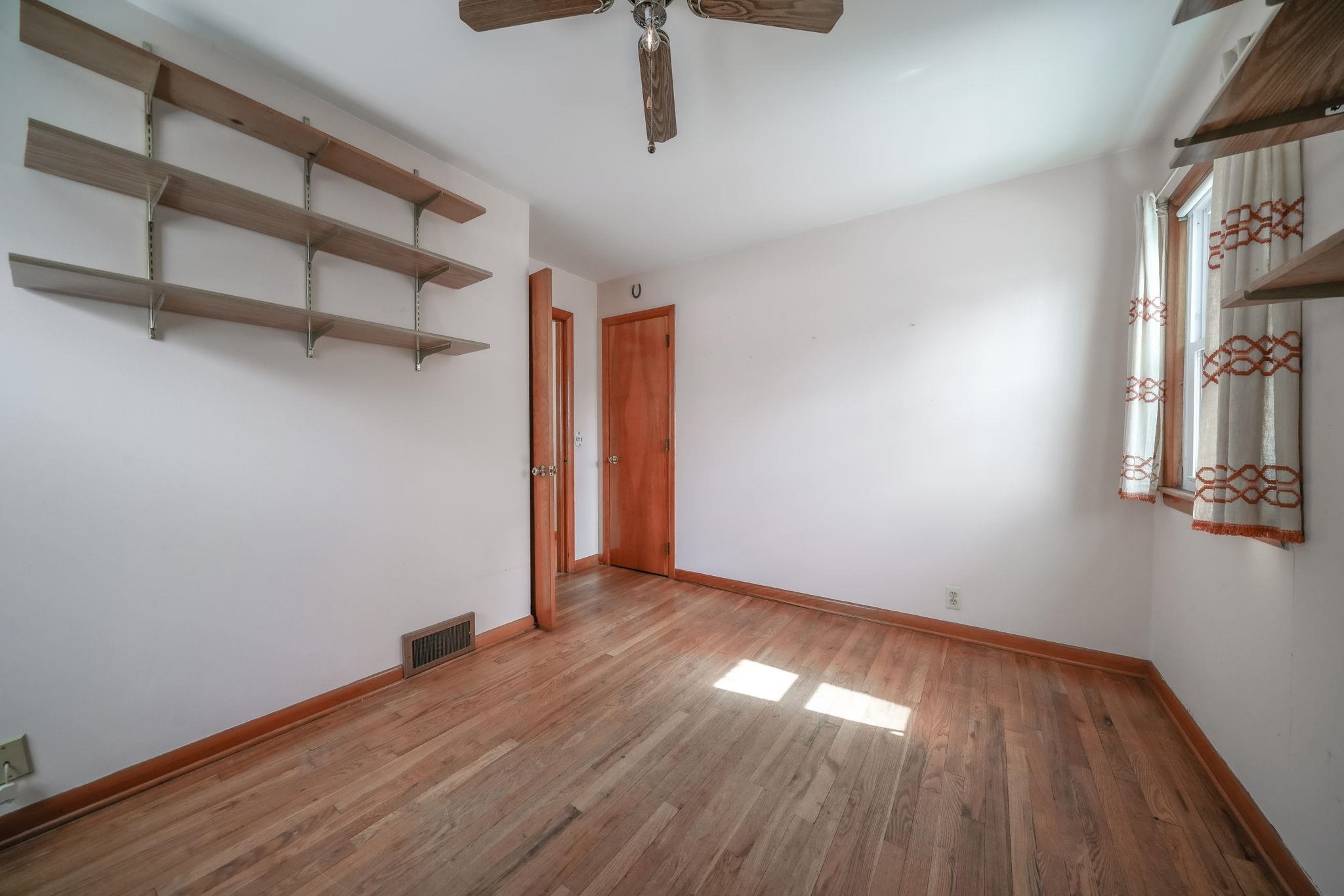808 South 5th Street Oregon, IL 61061 - Photo 21 of 39 a view of an empty room with wooden floor and a window