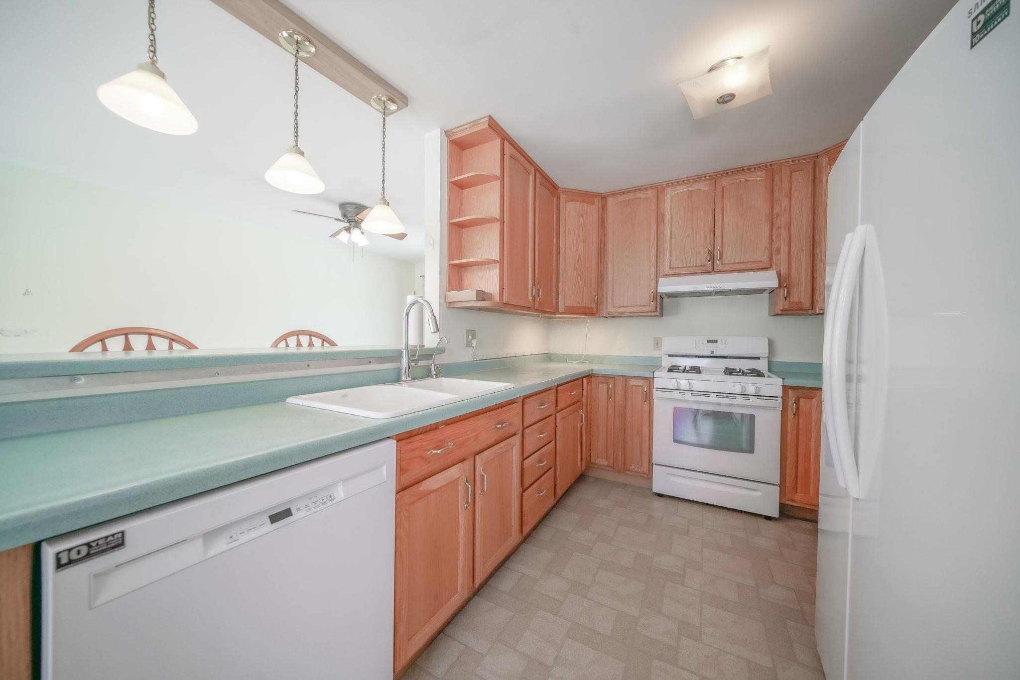 808 South 5th Street Oregon, IL 61061 - Photo 6 of 39 a kitchen with granite countertop a white stove sink and cabinets