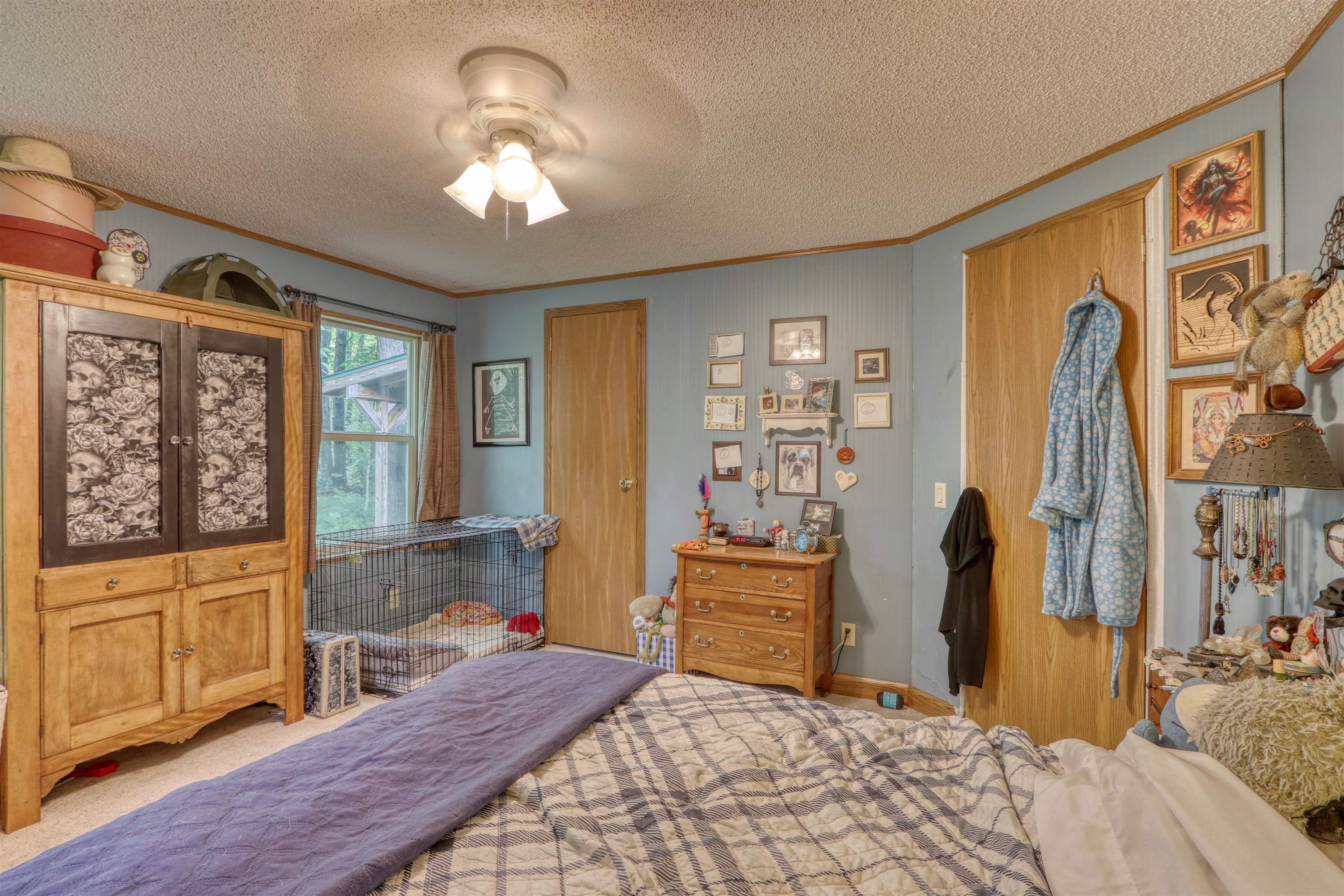 48400 Old Grade Road Cable, WI 54821 - Photo 27 of 58 Bedroom featuring ornamental molding, a textured ceiling, carpet floors, and a ceiling fan