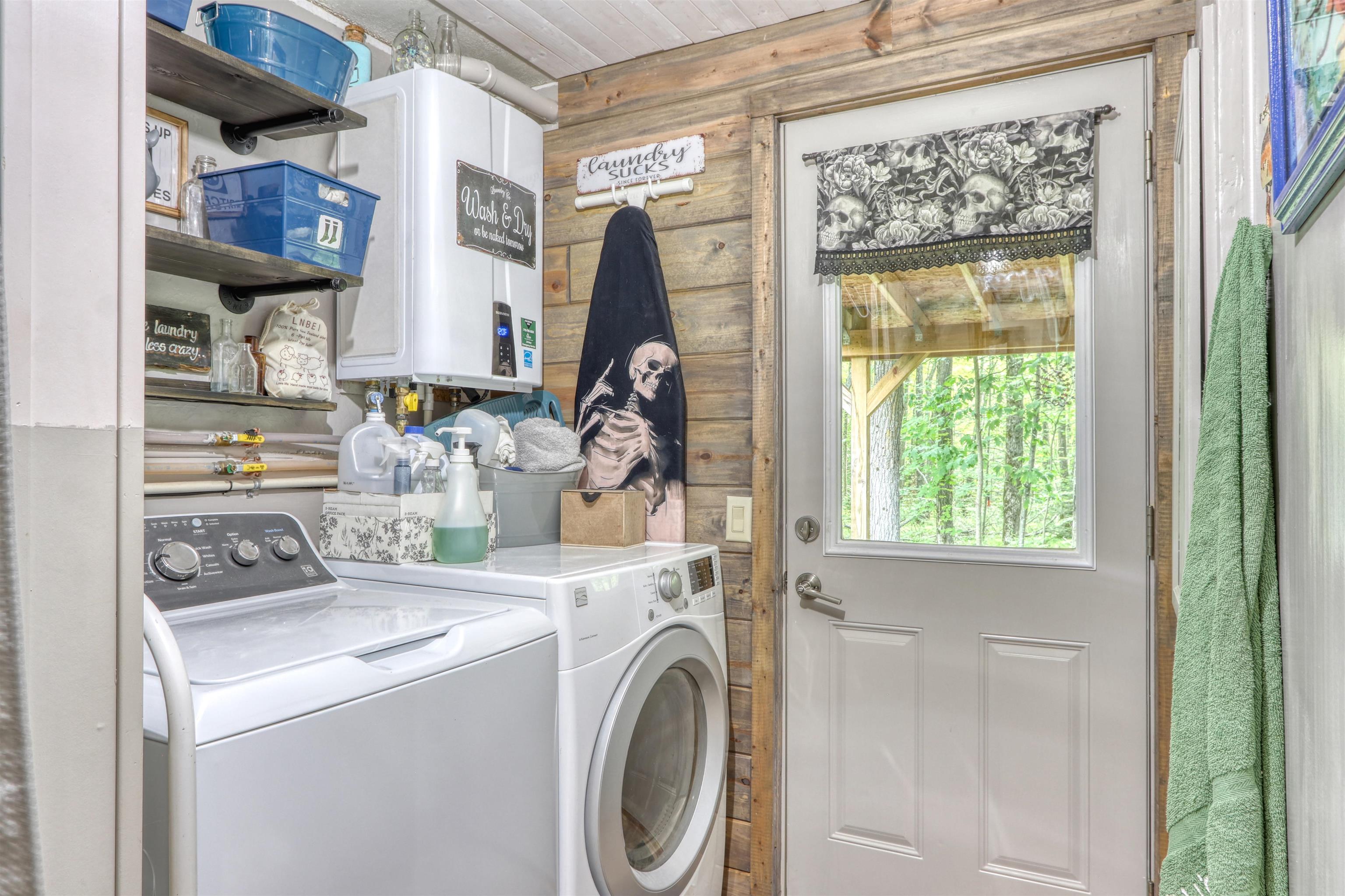 48400 Old Grade Road Cable, WI 54821 - Photo 34 of 58 Washroom featuring washing machine and dryer, wooden walls, tankless water heater, and wooden ceiling