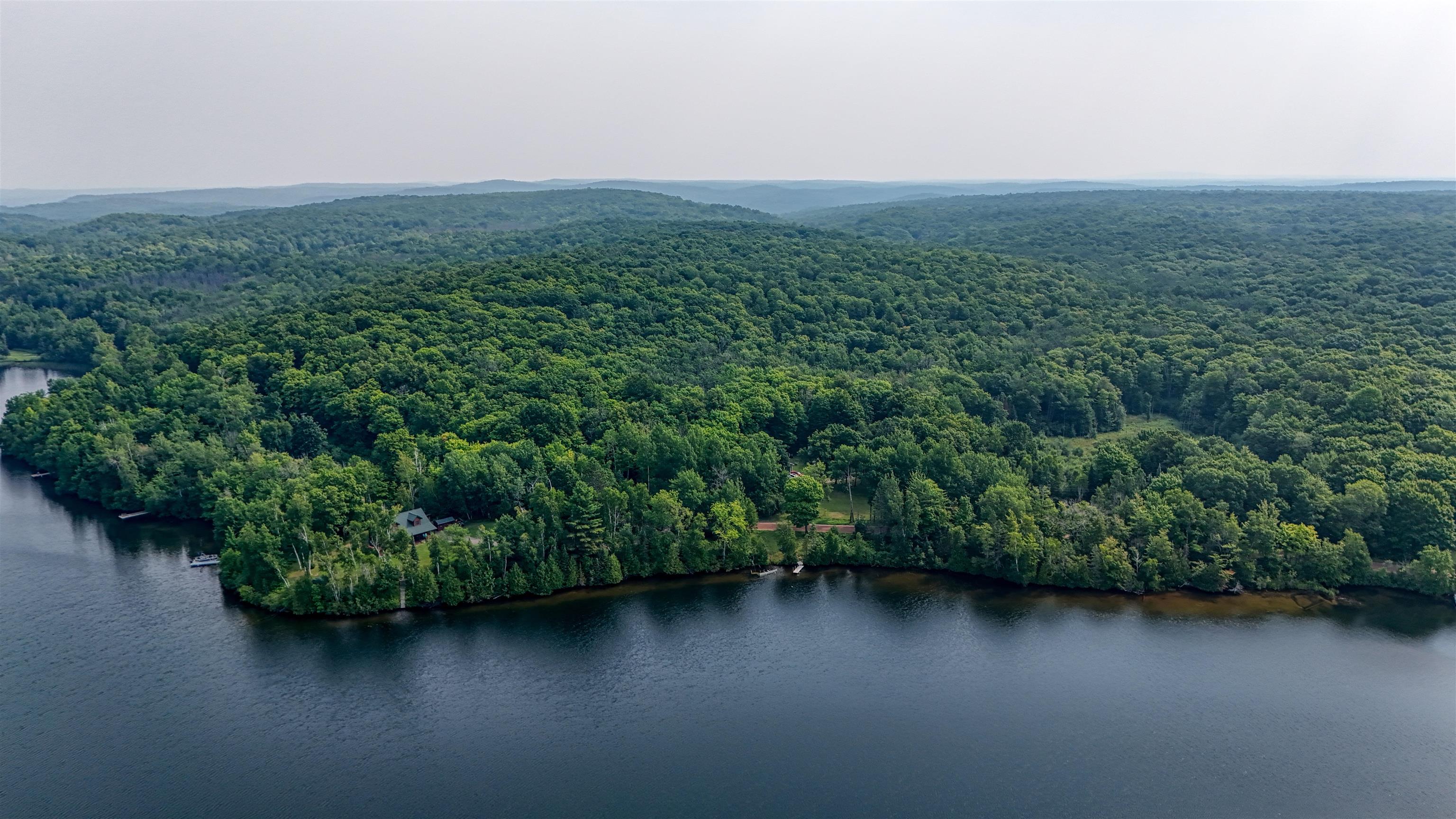48400 Old Grade Road Cable, WI 54821 - Photo 52 of 58 Aerial view of a nearby body of water and a heavily wooded area