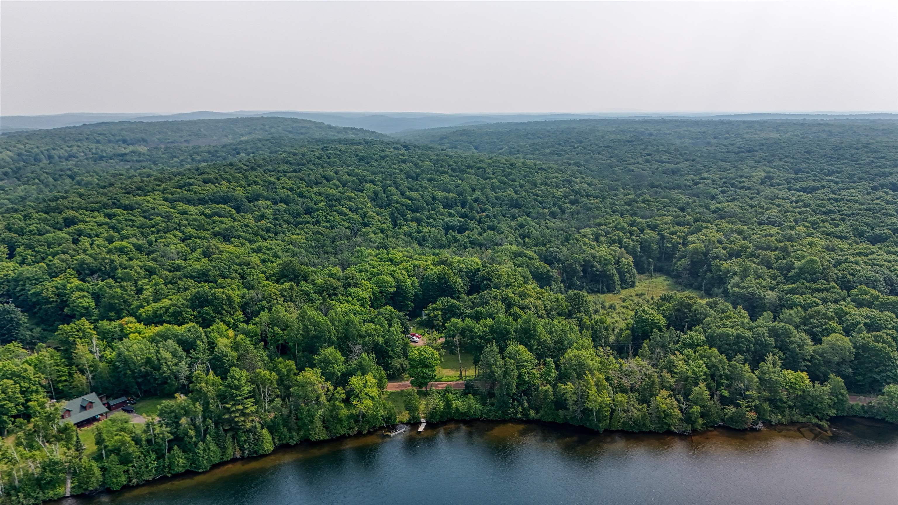 48400 Old Grade Road Cable, WI 54821 - Photo 53 of 58 Drone / aerial view of a large body of water and a forest