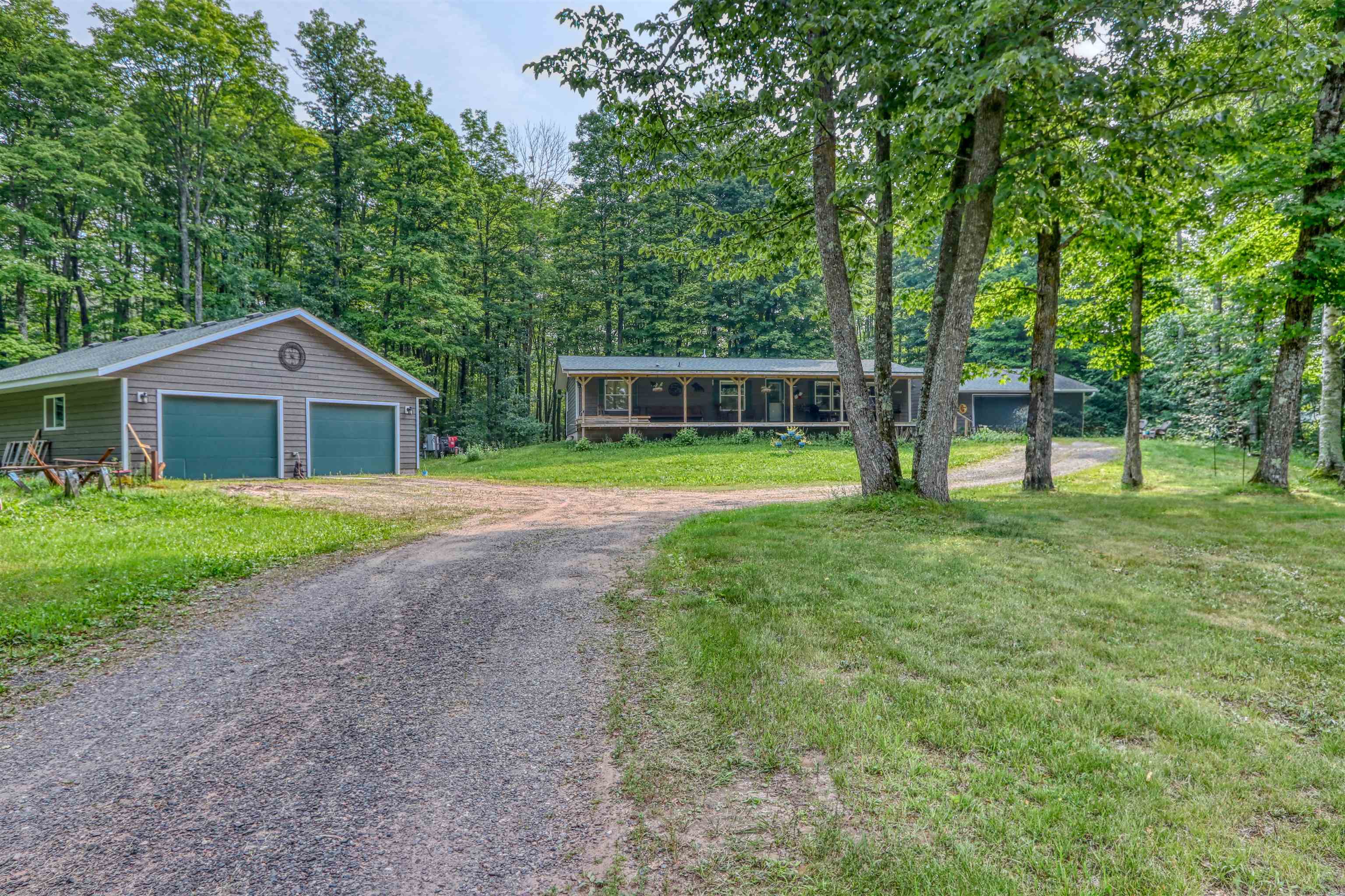 48400 Old Grade Road Cable, WI 54821 - Photo 57 of 58 View of front facade featuring an outbuilding, driveway, and a front yard