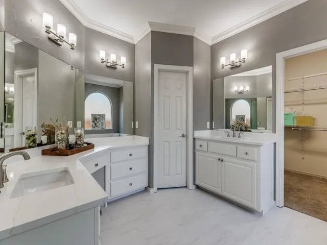 a bathroom with a double vanity sink and a mirror