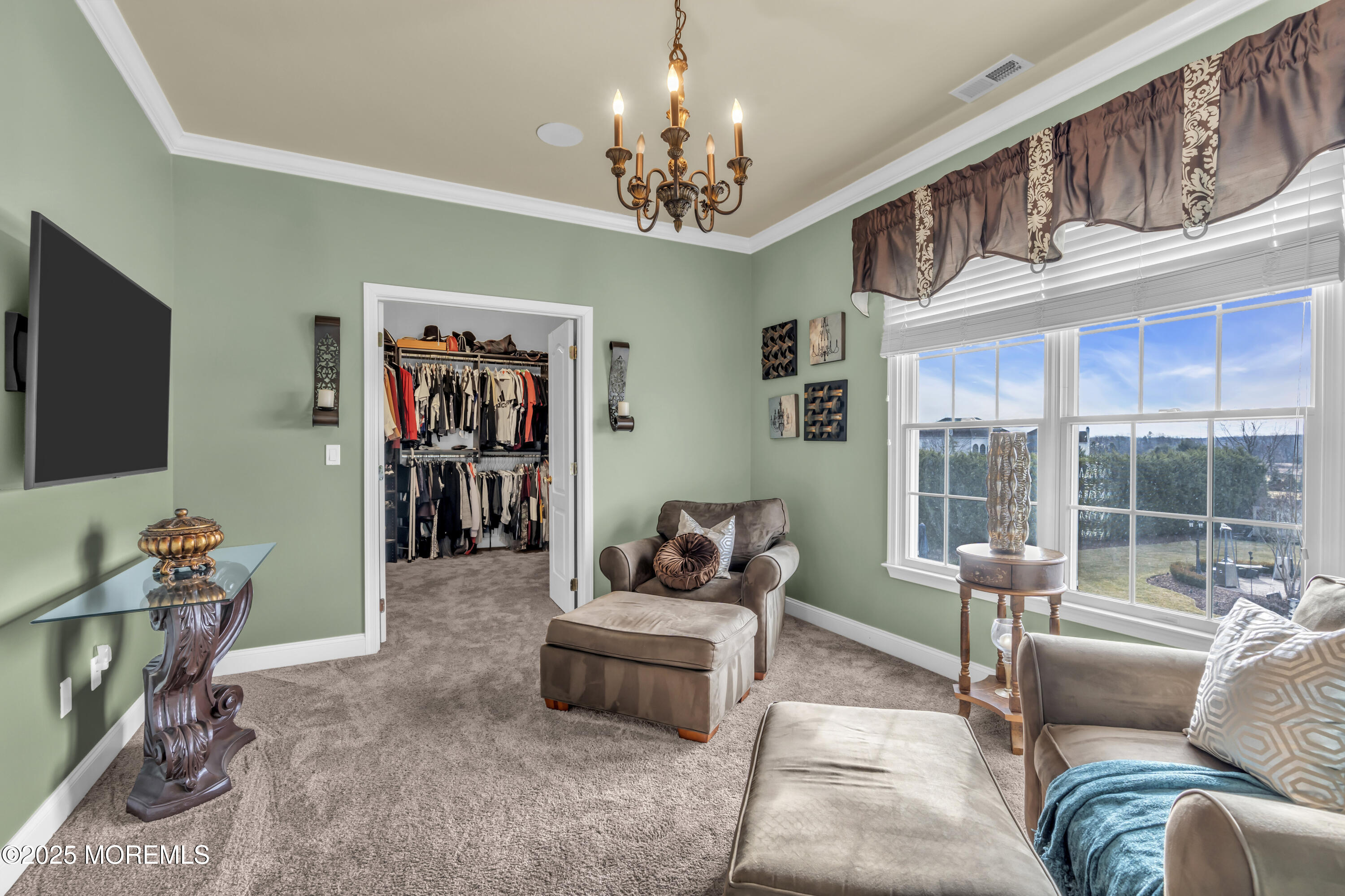 12 Courtney Court Freehold, NJ 07728 - Photo 67 of 99 a living room with furniture a chandelier and a flat screen tv