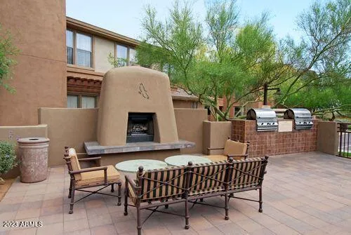 a view of a patio with a table and chairs