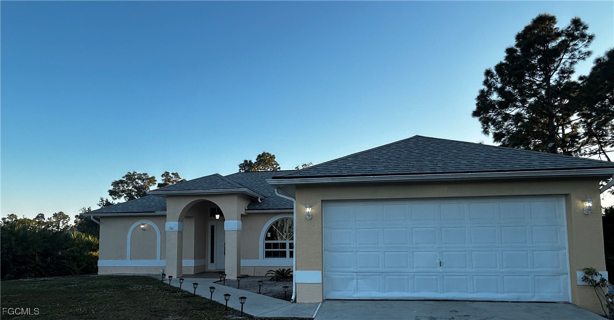 2811 40th Street Southwest Lehigh Acres, FL 33976 - Photo 1 of 13 a front view of a house with a yard