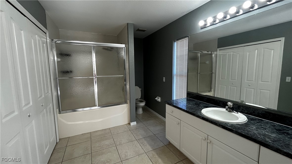 2811 40th Street Southwest Lehigh Acres, FL 33976 - Photo 12 of 13 a bathroom with a granite countertop sink a mirror and a bathtub