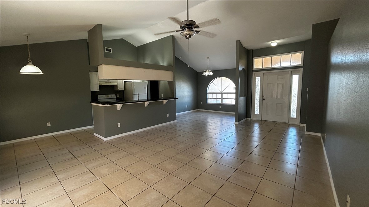 2811 40th Street Southwest Lehigh Acres, FL 33976 - Photo 2 of 13 an empty room with ceiling fan and windows