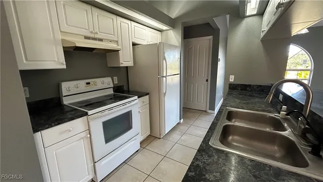 a kitchen with a stove and a refrigerator