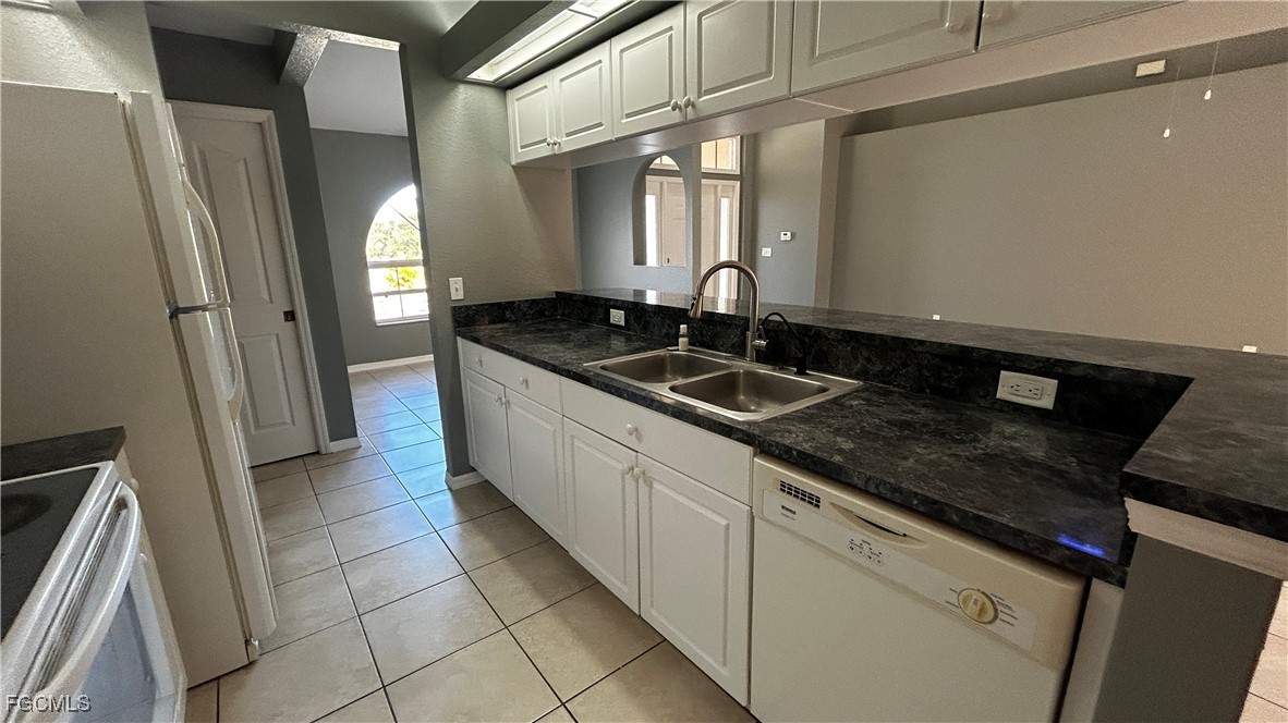 2811 40th Street Southwest Lehigh Acres, FL 33976 - Photo 5 of 13 a kitchen with granite countertop a sink and a stove