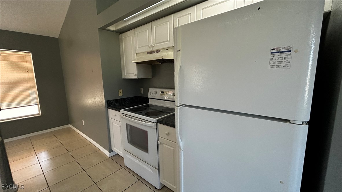 2811 40th Street Southwest Lehigh Acres, FL 33976 - Photo 6 of 13 a view of a kitchen with white cabinets