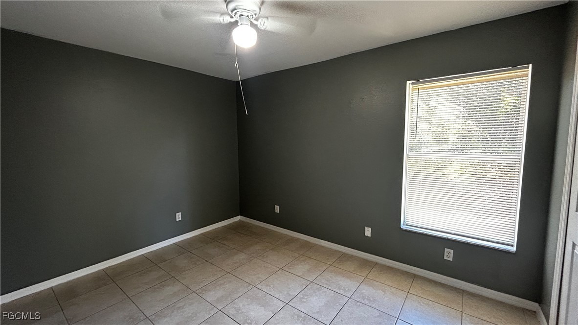 2811 40th Street Southwest Lehigh Acres, FL 33976 - Photo 8 of 13 a view of an empty room with a window