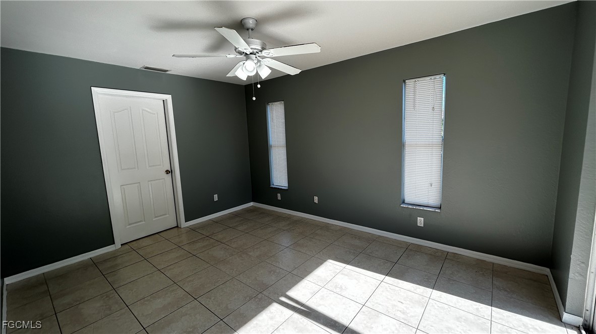 2811 40th Street Southwest Lehigh Acres, FL 33976 - Photo 10 of 13 a view of a chandelier fan and windows