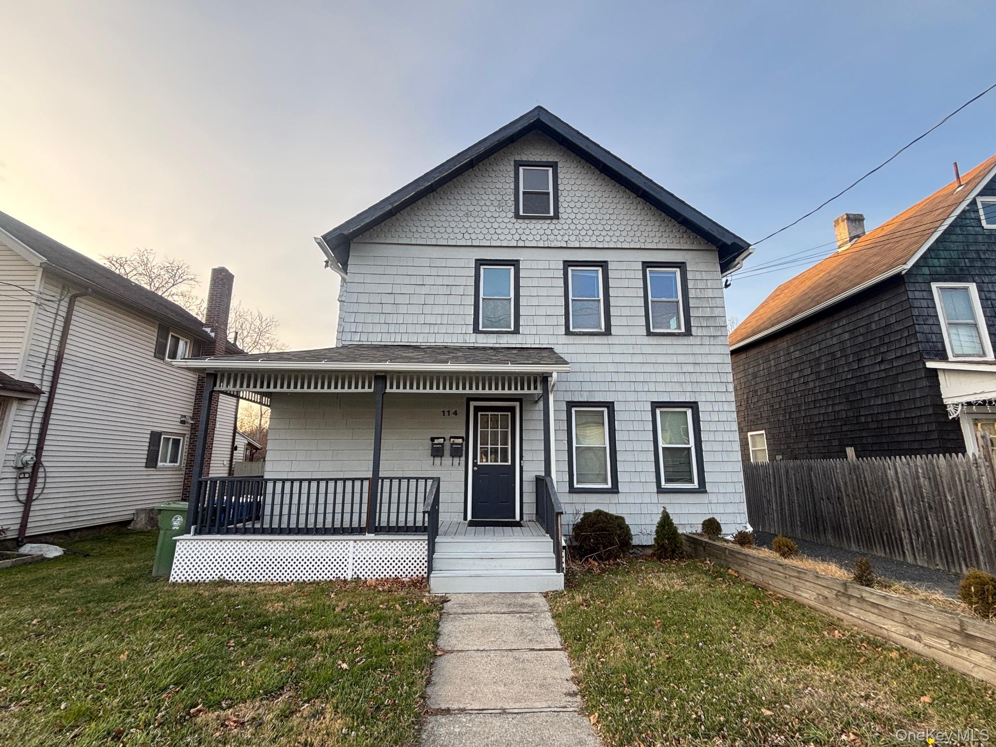 View of front of property with a porch and roof with shingles