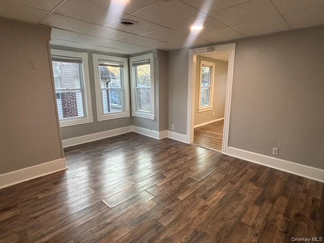 114 Sprague Avenue, Unit 2 Middletown, NY 10940 - Photo 4 of 13 Unfurnished room featuring a drop ceiling and dark wood-style flooring
