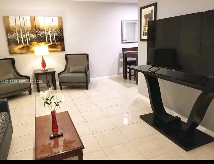 2023 Funston Street, Unit 2 Hollywood, FL 33020 - Photo 1 of 17 a living room with furniture rug and a flat screen tv