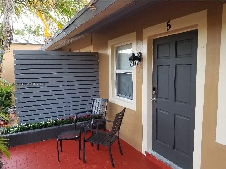 2023 Funston Street, Unit 2 Hollywood, FL 33020 - Photo 14 of 17 a view of a balcony with furniture and wooden floor