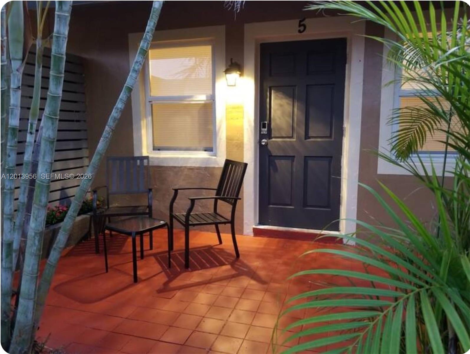 2023 Funston Street, Unit 2 Hollywood, FL 33020 - Photo 15 of 17 a view of balcony with two chairs and a potted plant