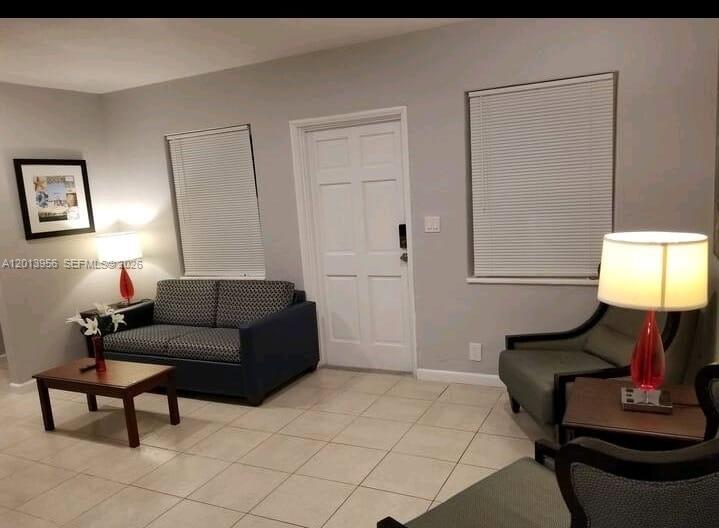 2023 Funston Street, Unit 2 Hollywood, FL 33020 - Photo 2 of 17 a living room with furniture and a lamp