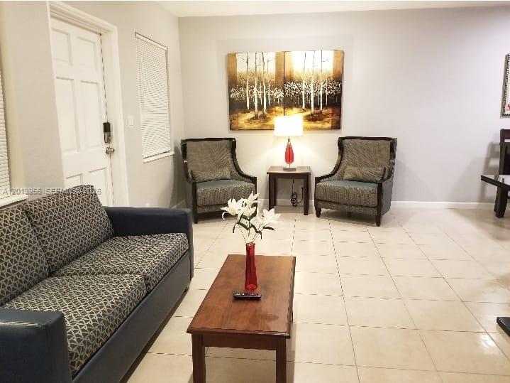 2023 Funston Street, Unit 2 Hollywood, FL 33020 - Photo 4 of 17 a living room with furniture and a large window