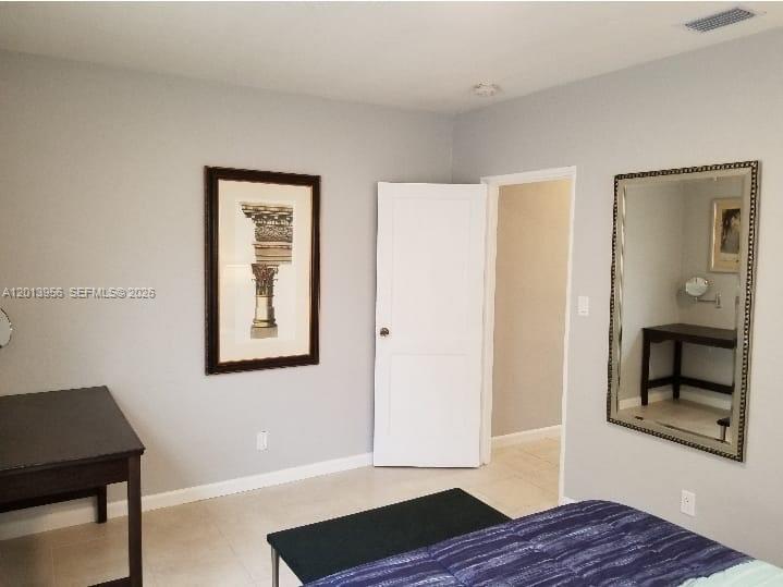 2023 Funston Street, Unit 2 Hollywood, FL 33020 - Photo 7 of 17 a view of an empty room with wooden floor and a window