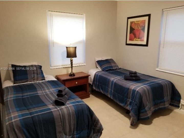 2023 Funston Street, Unit 2 Hollywood, FL 33020 - Photo 10 of 17 a bedroom with a bed and a lamp