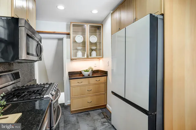 a bathroom with a sink toilet a mirror and shower