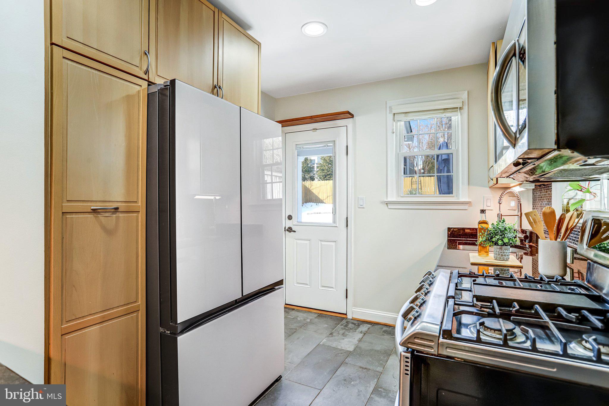 2708 Sycamore Street Alexandria, VA 22305 - Photo 24 of 71 a kitchen with stainless steel appliances granite countertop a refrigerator and a stove top oven