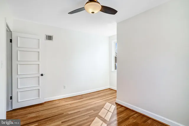 a view of room with a window and wooden floor