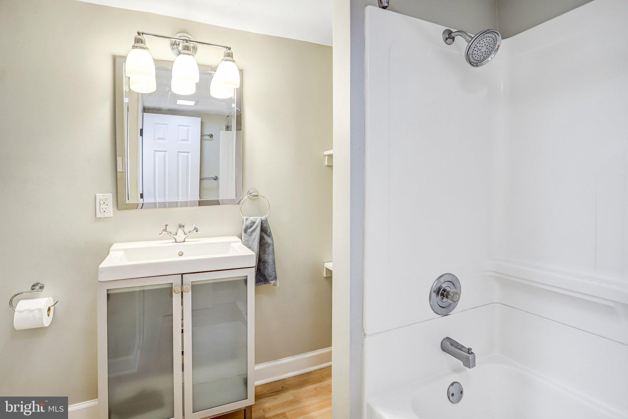 2708 Sycamore Street Alexandria, VA 22305 - Photo 44 of 71 a bathroom with a sink and mirror with bathtub