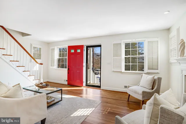 a living room with furniture and stairs