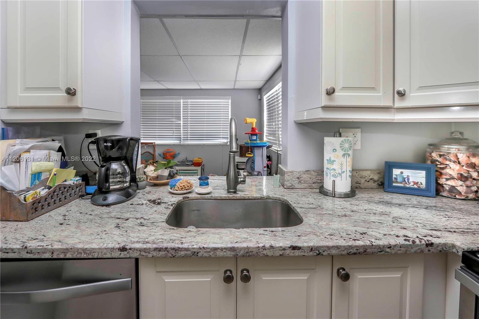 1711 North Park Road Hollywood, FL 33021 - Photo 11 of 29 a kitchen with granite countertop a sink a stove and cabinets