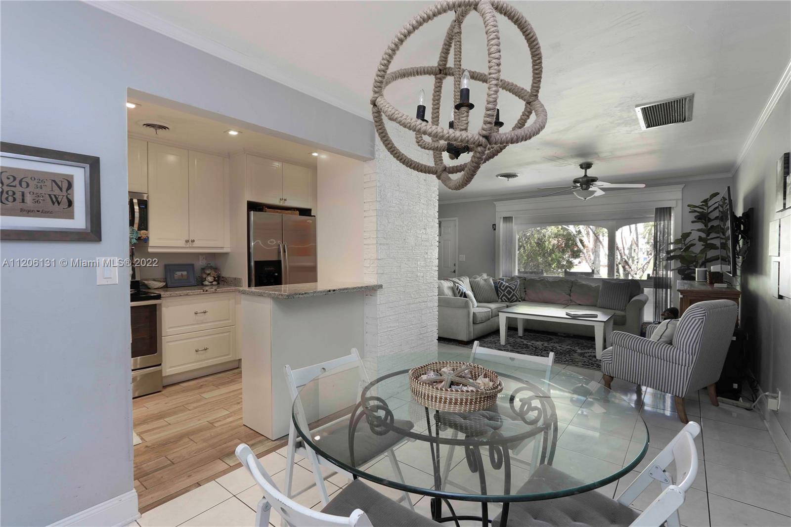 1711 North Park Road Hollywood, FL 33021 - Photo 14 of 29 a kitchen with a table chairs a stove and a chandelier