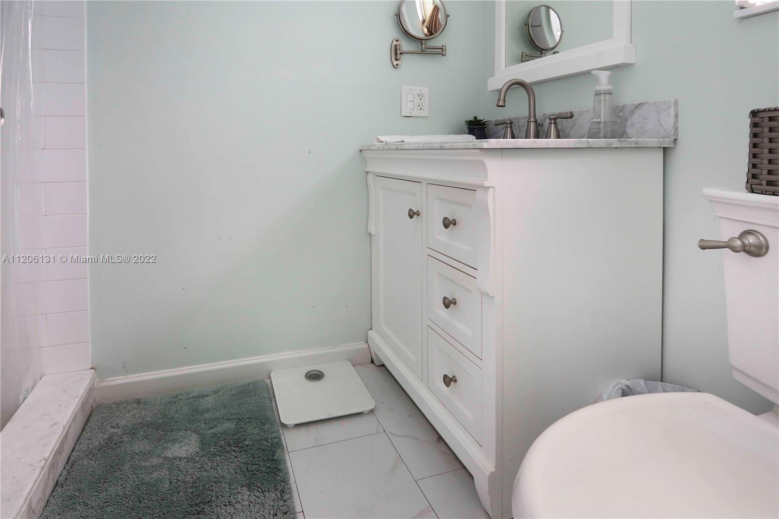 1711 North Park Road Hollywood, FL 33021 - Photo 22 of 29 a bathroom with a granite countertop sink a toilet and vanity