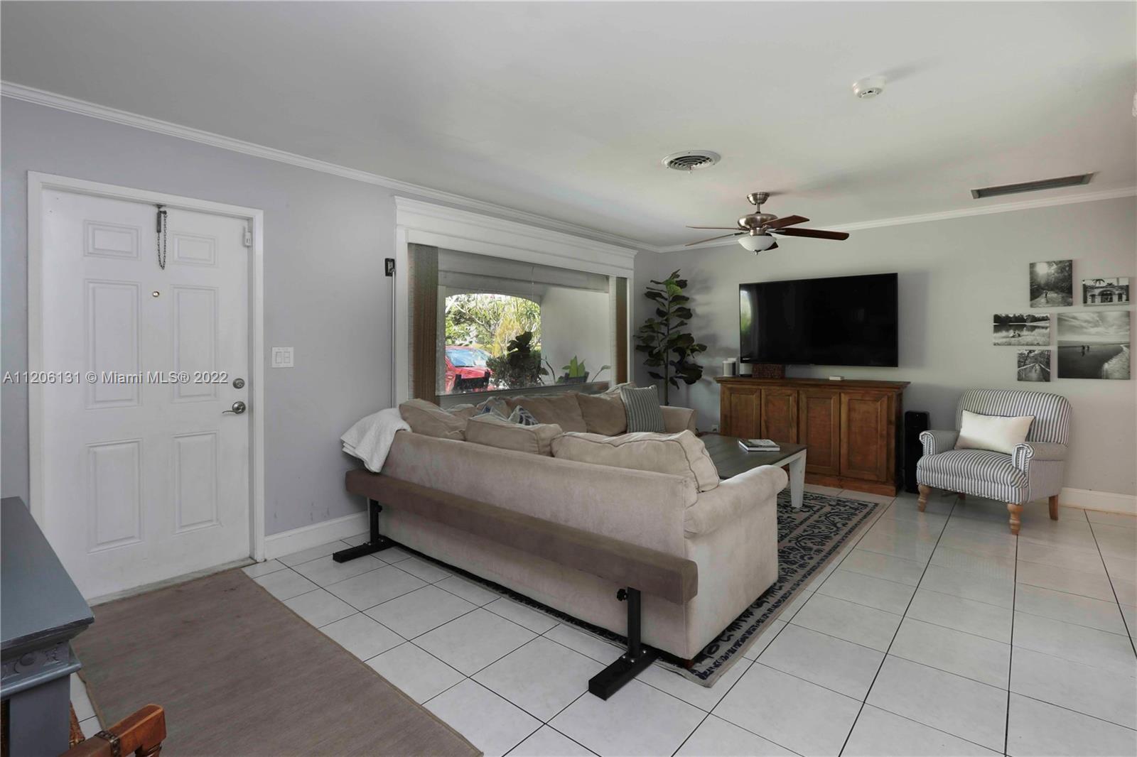 1711 North Park Road Hollywood, FL 33021 - Photo 4 of 29 a living room with furniture and a flat screen tv