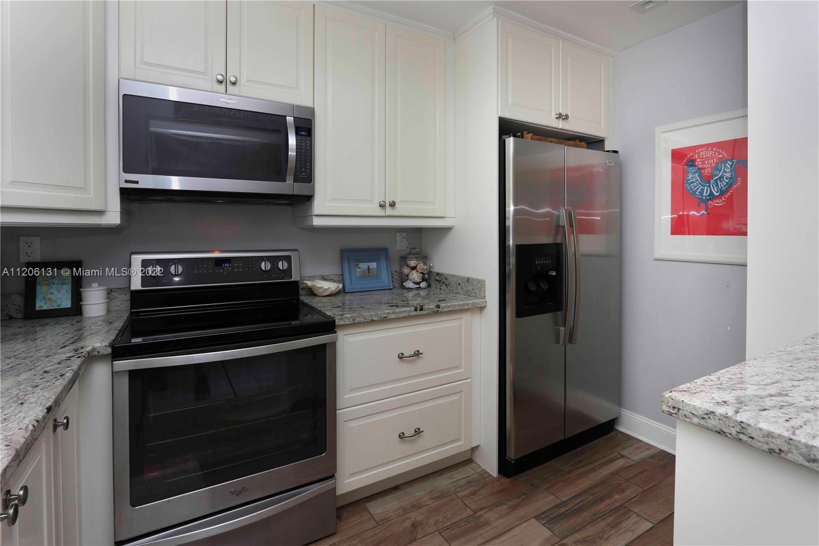 1711 North Park Road Hollywood, FL 33021 - Photo 8 of 29 a kitchen with stainless steel appliances granite countertop a stove microwave and refrigerator